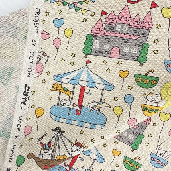 Selvage of Catland Cotton Linen Canvas Fabric by Cotton Kobayashi, style KTS-7183A, featuring cats at an amusement park, in cream, imported from Japan