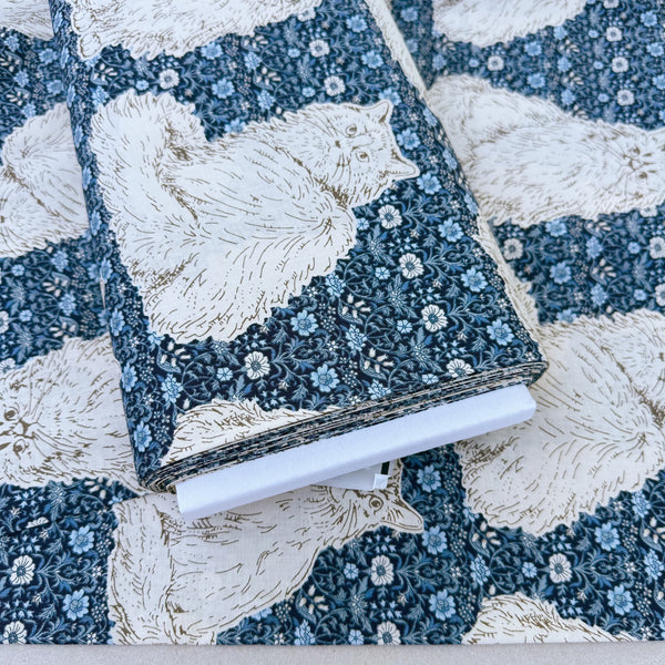 Bolt of Cats Playground cotton fabric in blue by Handworks Japan featuring large-scale cats on a petite floral background