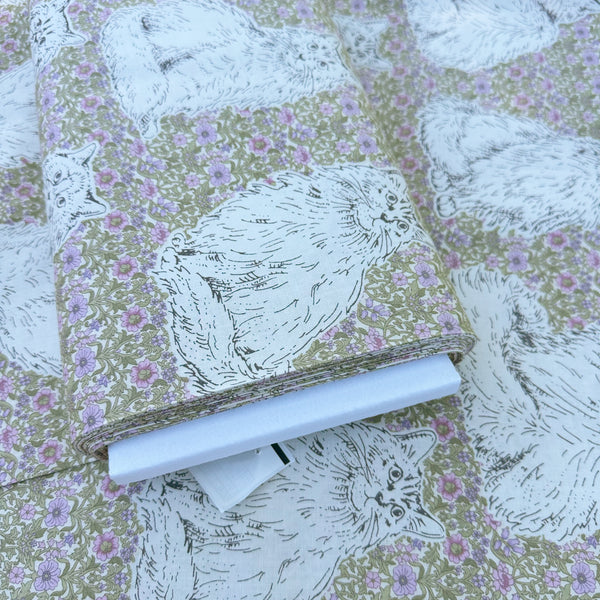 Bolt of Cats Playground cotton fabric in green and purple by Handworks Japan featuring large-scale cats on a petite floral background