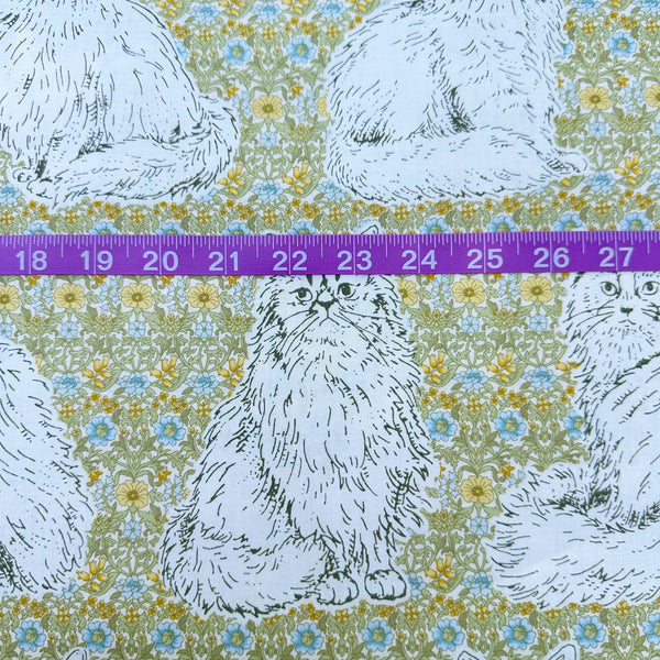 Scale of Cats Playground cotton fabric in green and yellow by Handworks Japan featuring large-scale cats on a petite floral background