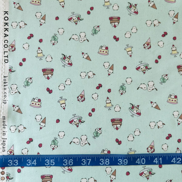 Scale of Chibi Puri Shimaenaga cotton fabric by Kokka in pale mint, style YKA-39050 2C