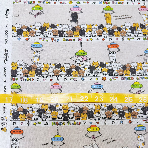 Scale of Claw Machine Cats canvas fabric in natural by Cotton Kobayashi, cotton linen blend with whimsical cat claw machine print