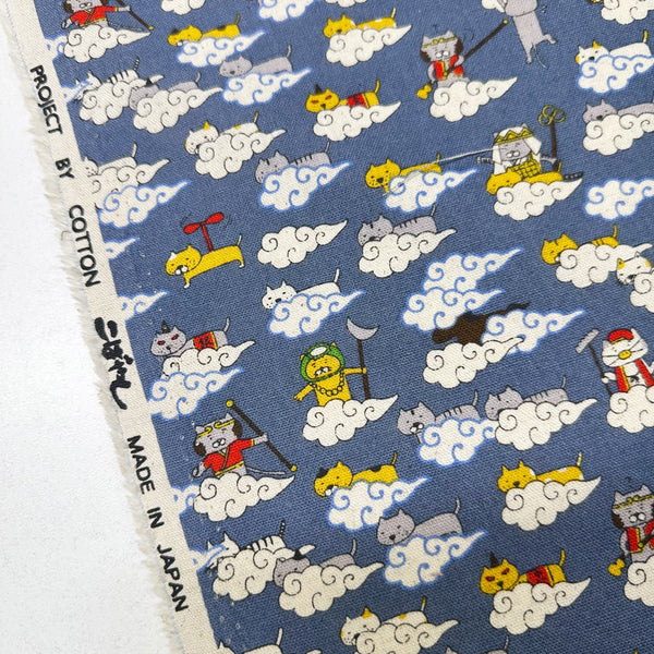 Selvage of Cloud Cats canvas fabric in steel cotton linen blend by Cotton Kobayashi featuring silly cats hanging out in clouds