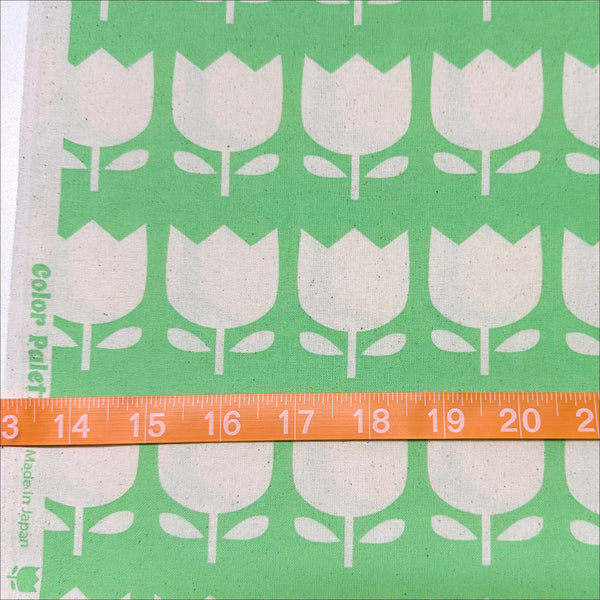Scale of Color Palette Tulips cotton fabric in green, Japanese import with cheerful tulip print on green background