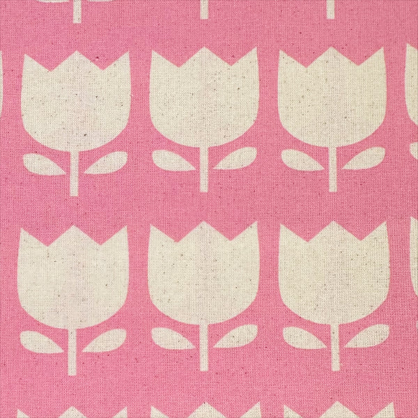 Close up of Color Palette Tulips cotton fabric in pink, Japanese import with cheerful tulip print on pink background