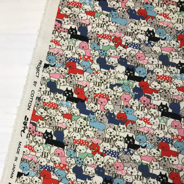 Selvage of Compact Cats fabric in natural featuring a quirky, densely packed cat print by Cotton Kobayashi