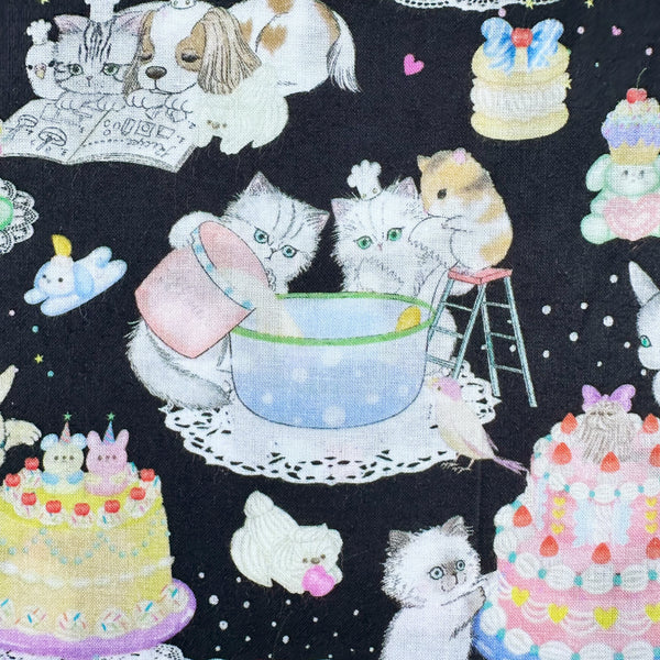 Cats in Cook Cats cotton lawn fabric in black by Yukiemon for Hokkoh featuring adorable animals baking cakes and preparing sweet treats, imported from Japan