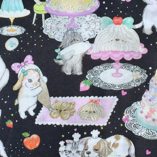 Bunnies in Cook Cats cotton lawn fabric in black by Yukiemon for Hokkoh featuring adorable animals baking cakes and preparing sweet treats, imported from Japan