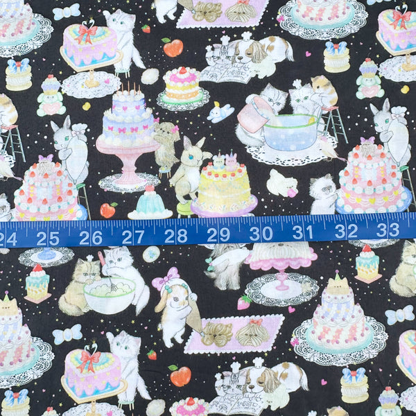 Scale of Cook Cats cotton lawn fabric in black by Yukiemon for Hokkoh featuring adorable animals baking cakes and preparing sweet treats, imported from Japan