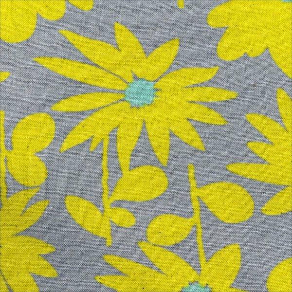 Close up of Daisy Daisy cotton linen canvas fabric by Cotton Kobayashi in yellow and gray