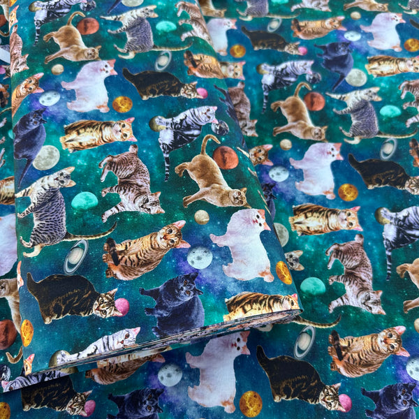 Bolt of Day Dream Cat cotton fabric in Teal by Nora featuring photo-real cats scattered among moons and planets on a teal sky background