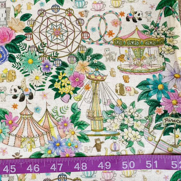 Scale of Decoration Park cotton linen fabric by Yukiemon for Hokkoh featuring a charming delicately illustrated vintage-style fun fair scene with florals, carousel rides, circus tents, and whimsical animals on a natural background, imported from Japan