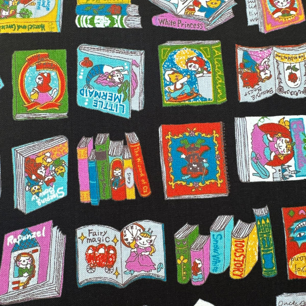 Close up of Dreaming Cat Story Books cotton fabric in black, imported from Japan