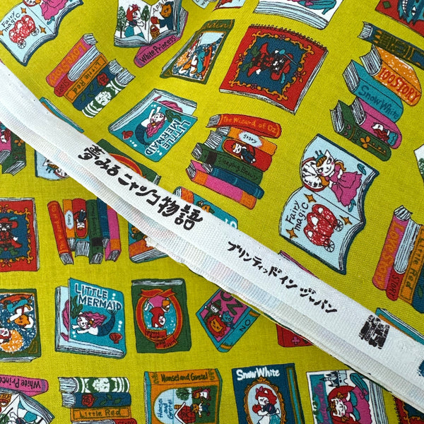 Selvage of Dreaming Cat Story Books cotton fabric in chartreuse, imported from Japan