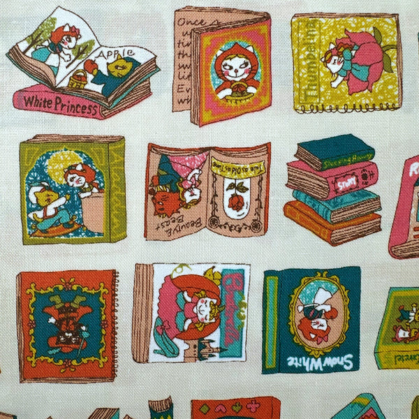 Close up of Dreaming Cat Story Books cotton fabric in ivory, imported from Japan