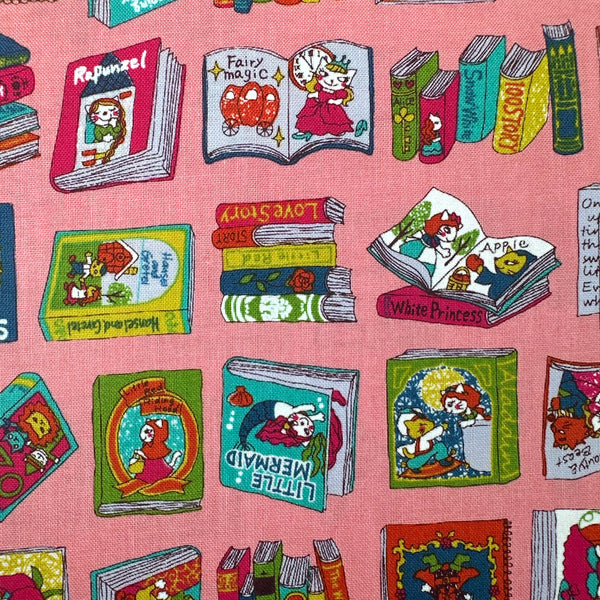 Close up of Dreaming Cat Story Books cotton fabric in pink, imported from Japan