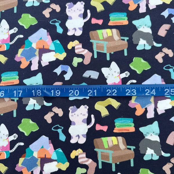 Scale of Dressed Up Cats cotton fabric in midnight by Nora featuring cats with clothing and laundry illustrations imported from Japan