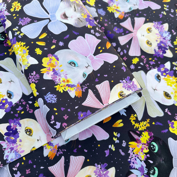 Bolt of Dressed Up Cats cotton fabric in purple by Nora featuring cats with ribbons and flower crowns imported from Japan