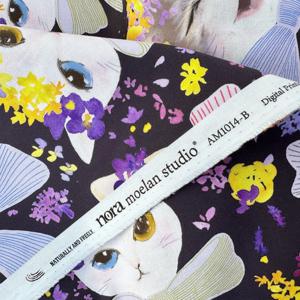 Selvage of Dressed Up Cats cotton fabric in purple by Nora featuring cats with ribbons and flower crowns imported from Japan