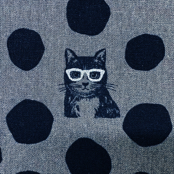 Close up of Echino Nekonoe Cat Cotton Linen Canvas Fabric by Etsuko Furuya for Kokka Japan, featuring cat portraits and polka dots in charcoal and black