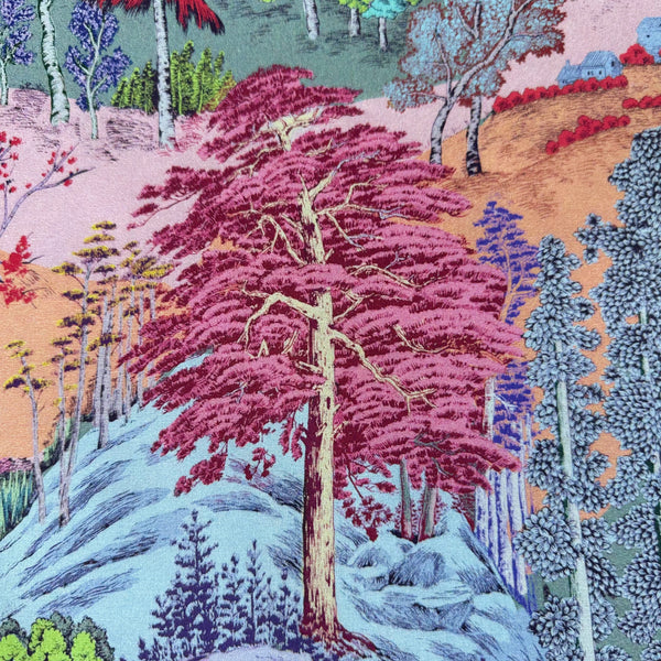Close up of Eden Panorama cotton fabric by Nora featuring a richly detailed landscape with a flowing river, dense forest, and vibrant colors, imported from Japan