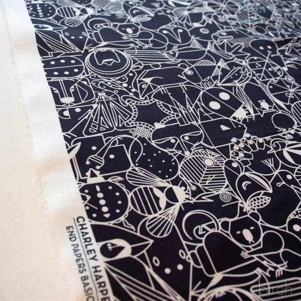 Selvage of End Papers black organic cotton poplin fabric by Charley Harper for Birch Fabrics, featuring mid-century modern illustrations