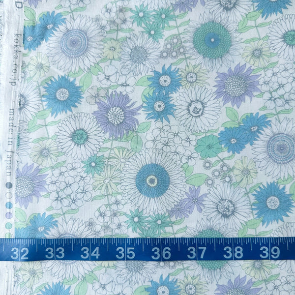 Flownny Retro Floral cotton lawn fabric by Kokka in light blue, shown with a tape measure for scale, style NFA-1050 54B