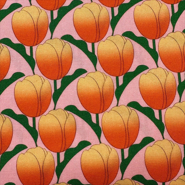 Close up of Tulip cotton fabric by Nora in pink coral, fat quarter