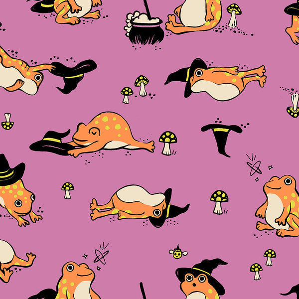 Frogmiliars cotton fabric by Ruby Star Society featuring frogs and witch hats on a heliotrope background.