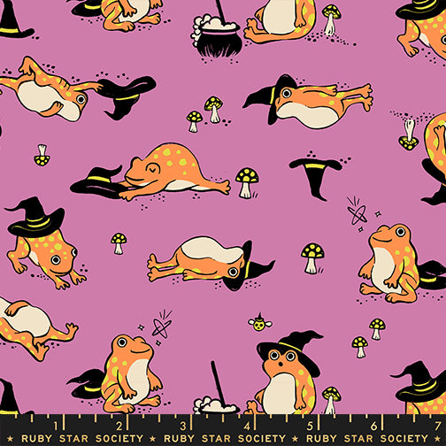 Scale of Frogmiliars cotton fabric by Ruby Star Society featuring frogs and witch hats on a heliotrope background.