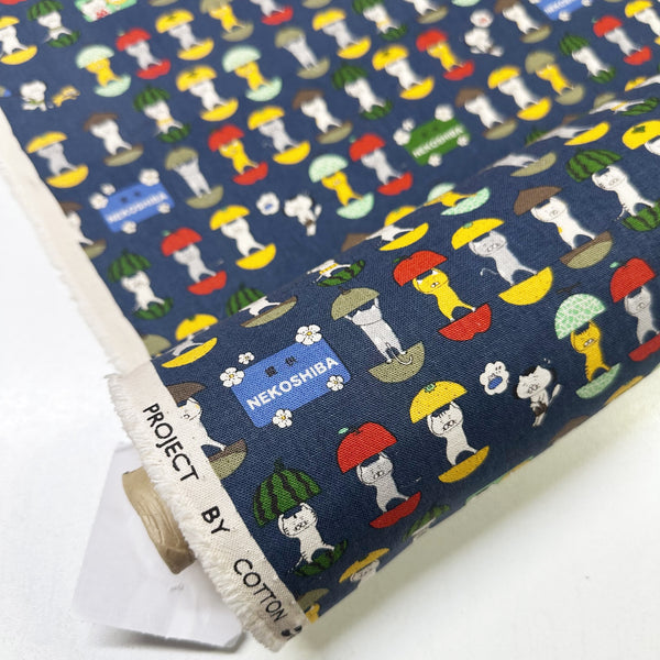 Bolt of Fruit Cats Canvas Fabric in Indigo by Cotton Kobayashi – cats standing inside halved fruits on cotton linen canvas, imported from Japan