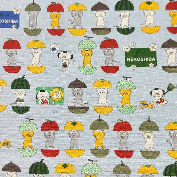 Fruit Cats Canvas Fabric in Light Blue by Cotton Kobayashi – cats standing inside halved fruits on cotton linen canvas, imported from Japan