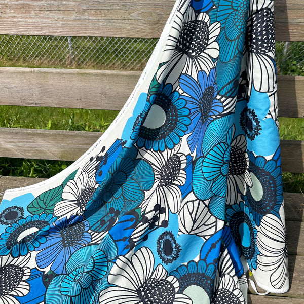 Bolt of Garden Flowers cotton fabric by Kokka featuring oversized blue and black florals in a Scandinavian-inspired design