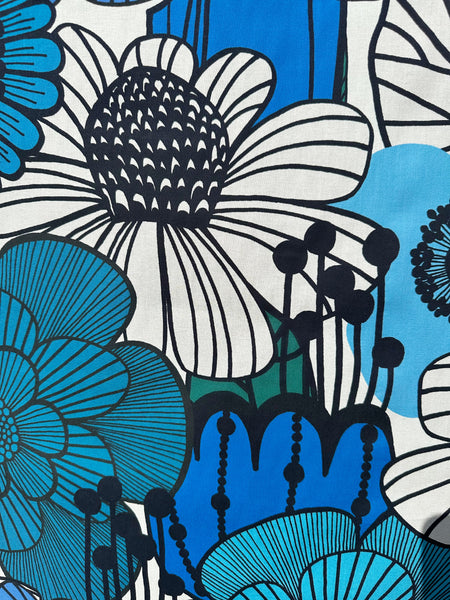Close up of Garden Flowers cotton fabric by Kokka featuring oversized blue and black florals in a Scandinavian-inspired design