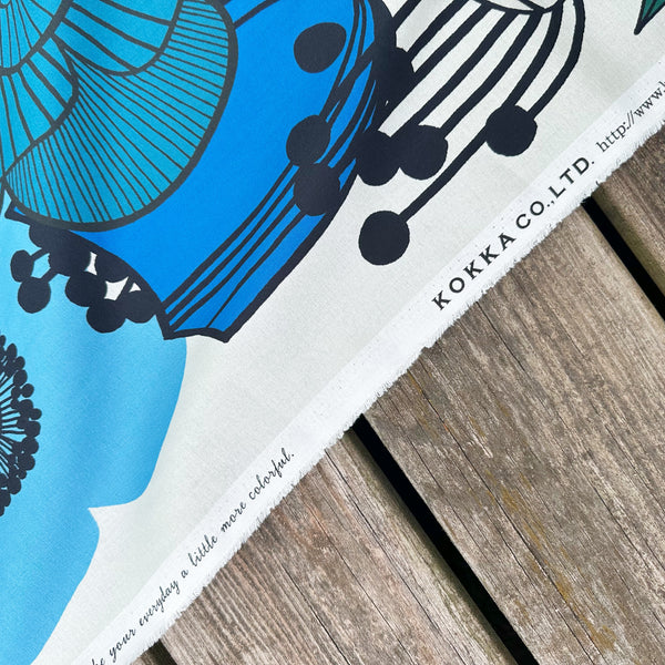 Selvage of Garden Flowers cotton fabric by Kokka featuring oversized blue and black florals in a Scandinavian-inspired design