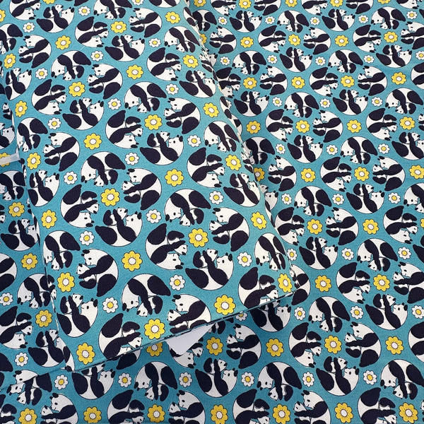 Bolt of Goro Koro Panda Cotton Oxford Fabric in Blue by Anyan for Cotorienne and Yuwa featuring adorable rolling pandas on a blue background.