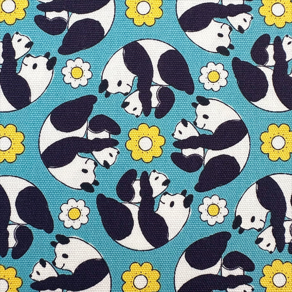 Close up of Goro Koro Panda Cotton Oxford Fabric in Blue by Anyan for Cotorienne and Yuwa featuring adorable rolling pandas on a blue background.