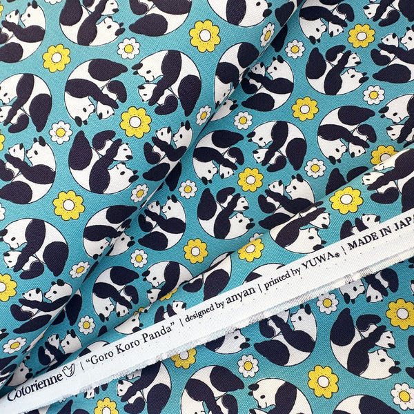 Selvage of Goro Koro Panda Cotton Oxford Fabric in Blue by Anyan for Cotorienne and Yuwa featuring adorable rolling pandas on a blue background.