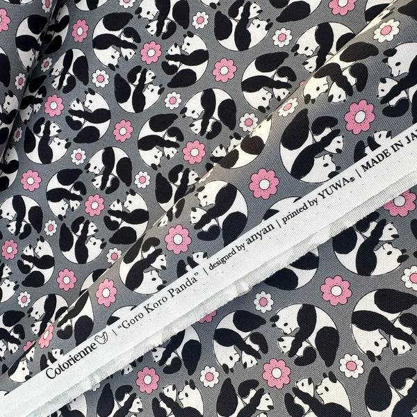 Selvage of Goro Koro Panda Cotton Oxford Fabric in Gray by Anyan for Cotorienne and Yuwa featuring adorable rolling pandas on a gray background.