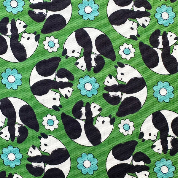 Close up of Goro Koro Panda Cotton Oxford Fabric in Green by Anyan for Cotorienne and Yuwa featuring adorable rolling pandas on a green background.