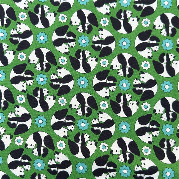 Goro Koro Panda Cotton Oxford Fabric in Green by Anyan for Cotorienne and Yuwa featuring adorable rolling pandas on a green background.