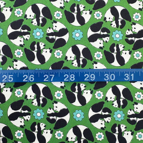 Scale of Goro Koro Panda Cotton Oxford Fabric in Green by Anyan for Cotorienne and Yuwa featuring adorable rolling pandas on a green background.
