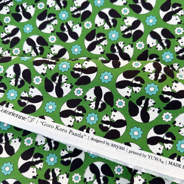 Selvage of Goro Koro Panda Cotton Oxford Fabric in Green by Anyan for Cotorienne and Yuwa featuring adorable rolling pandas on a green background.