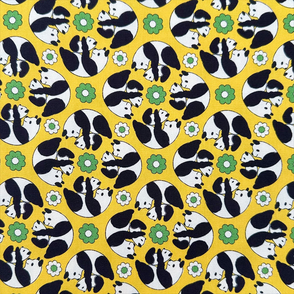 Goro Koro Panda Cotton Oxford Fabric in Yellow by Anyan for Cotorienne and Yuwa featuring adorable rolling pandas on a yellow background.