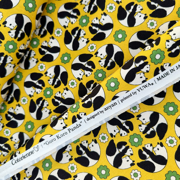 Selvage of Goro Koro Panda Cotton Oxford Fabric in Yellow by Anyan for Cotorienne and Yuwa featuring adorable rolling pandas on a yellow background.