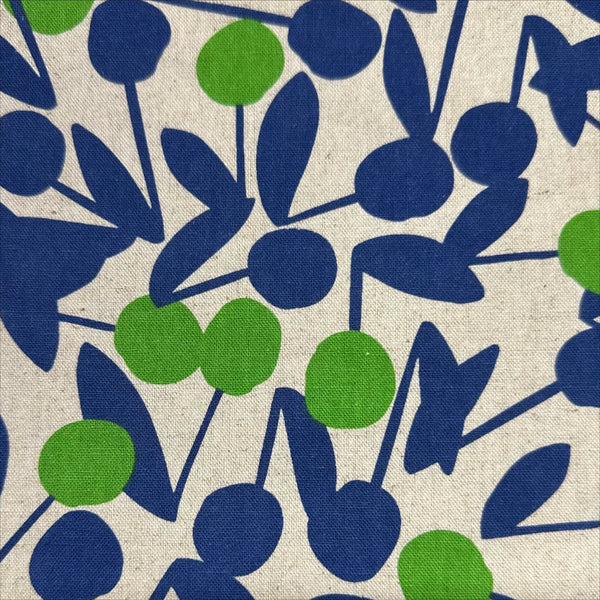 Close up of Green Cherry Pom Pom canvas fabric by Sevenberry, cotton linen blend