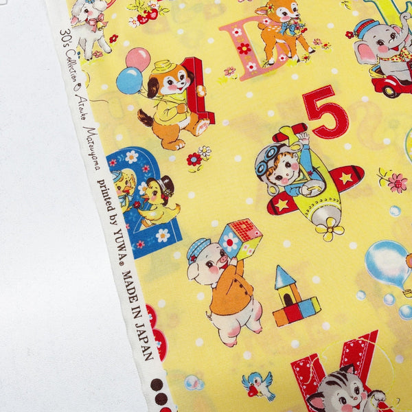 Selvage of Happy Baby cotton fabric by Yuwa in yellow, AT822366 C