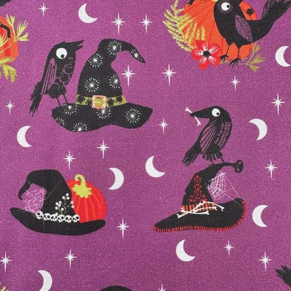 Close up of Hocus Pocus Beaks and Brims cotton fabric by Helen Black featuring crows and witch hats on a black Halloween background