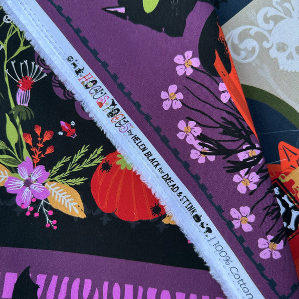 Selvage of Hocus Pocus Halloween panel cotton fabric by Helen Black featuring spooky seasonal illustrations, pumpkins, and black cats