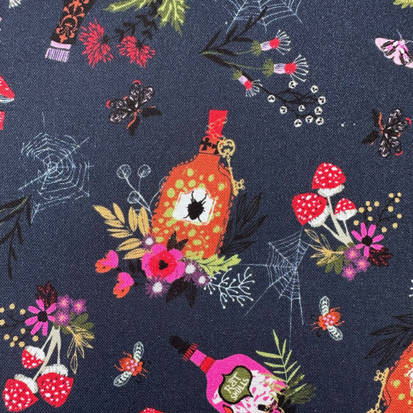 Close up of Hocus Pocus Spellbound cotton fabric by Helen Black featuring potion bottles, spider webs, and mushrooms on a black background